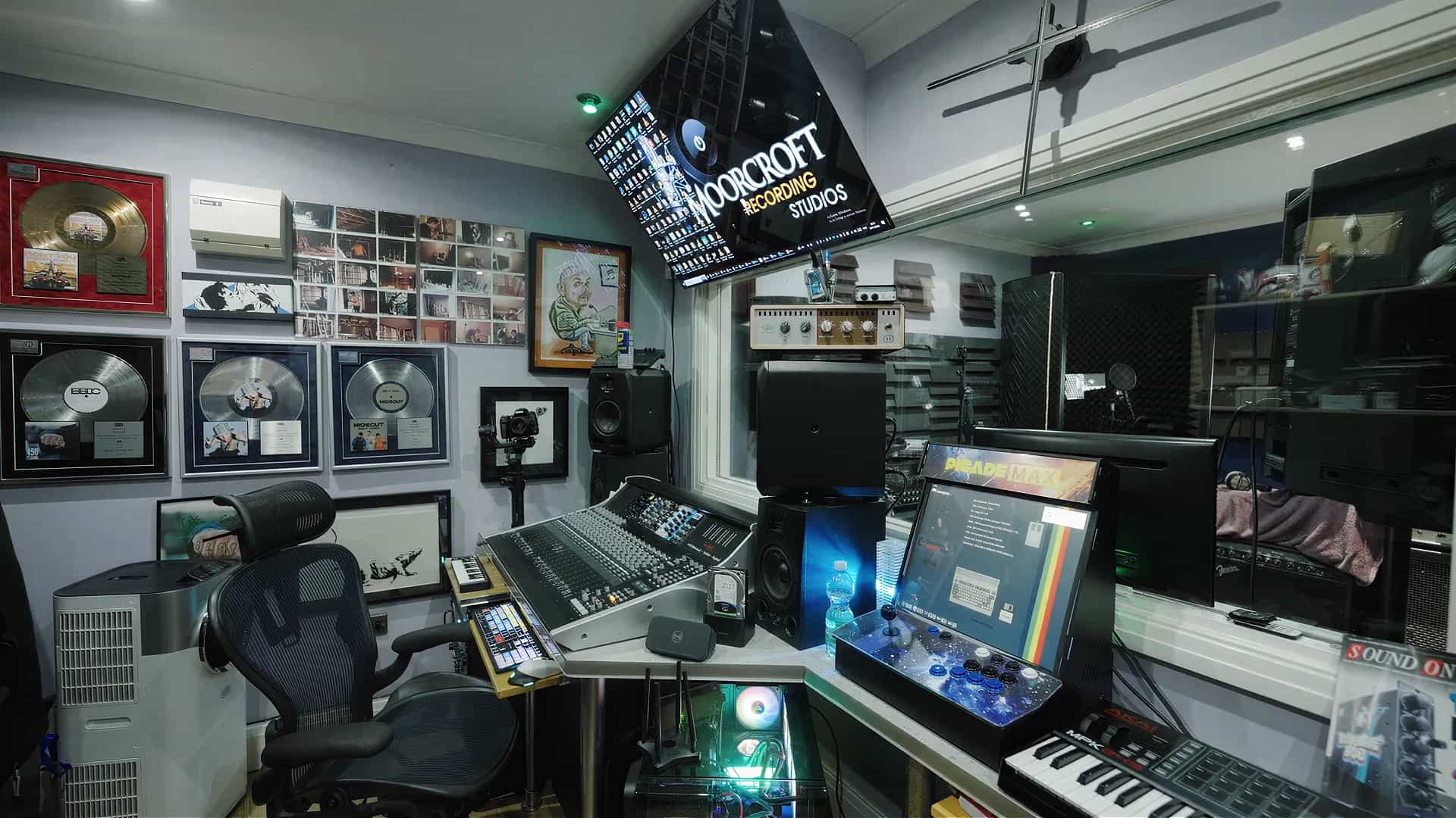 Moorcroft Recording Studios control room with mixing console, gold and platinum records, and studio equipment