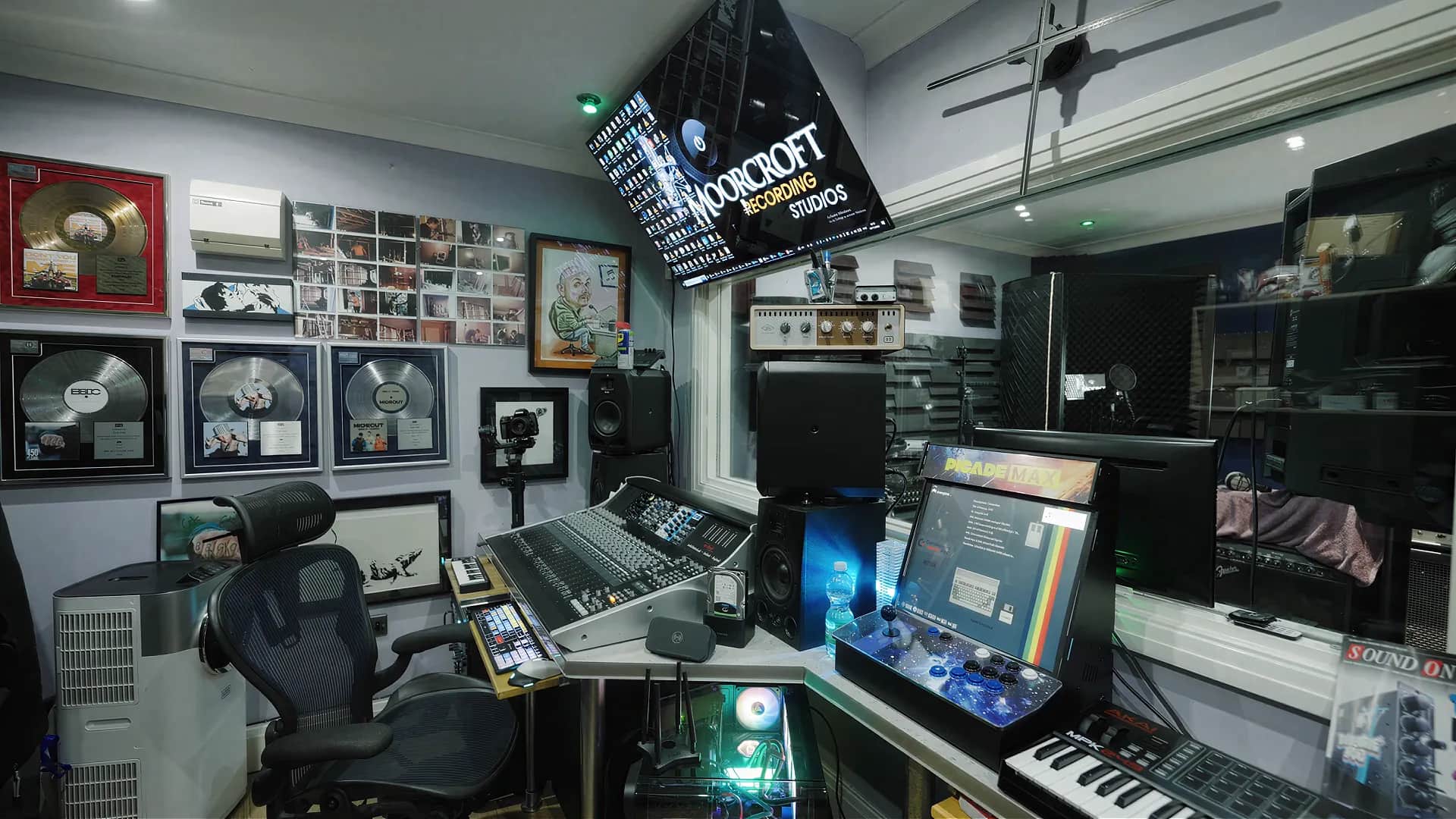 Moorcroft Recording Studios control room with mixing console, gold and platinum records, and studio equipment