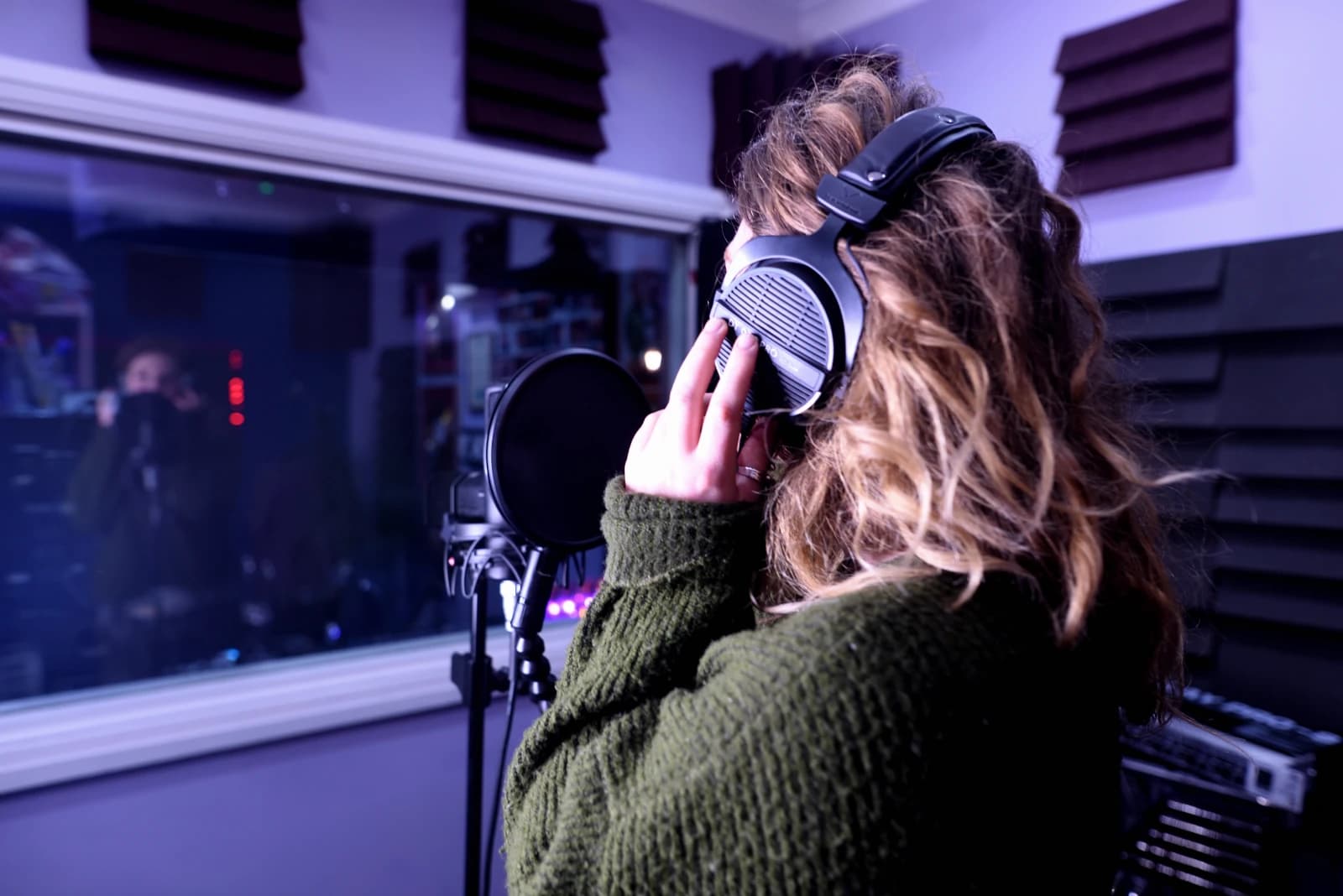 Vocalist recording in the booth at Moorcroft Studios
