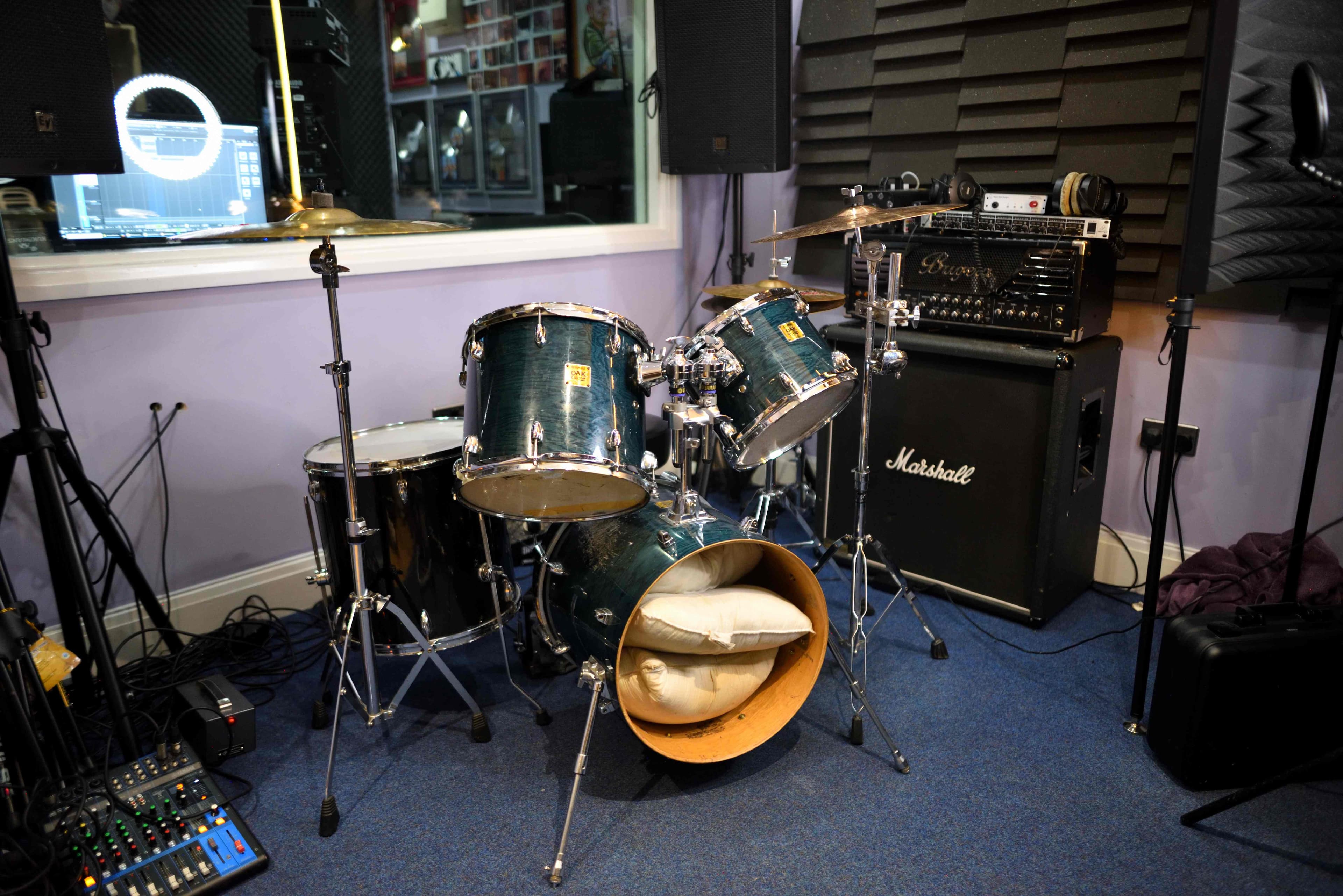 Live room with a Yamaha drum kit and guitar amplifiers at Moorcroft Studios