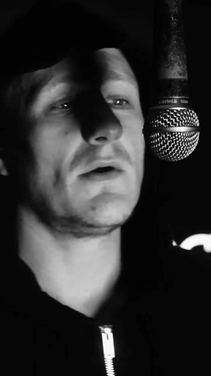 Artist MC Innes recording vocals into a studio microphone at Moorcroft Studios
